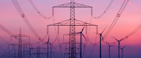 Stromnetz mit Windkraftanlagen im Hintergrund Stromnetz mit Windkraftanlagen im Hintergrund